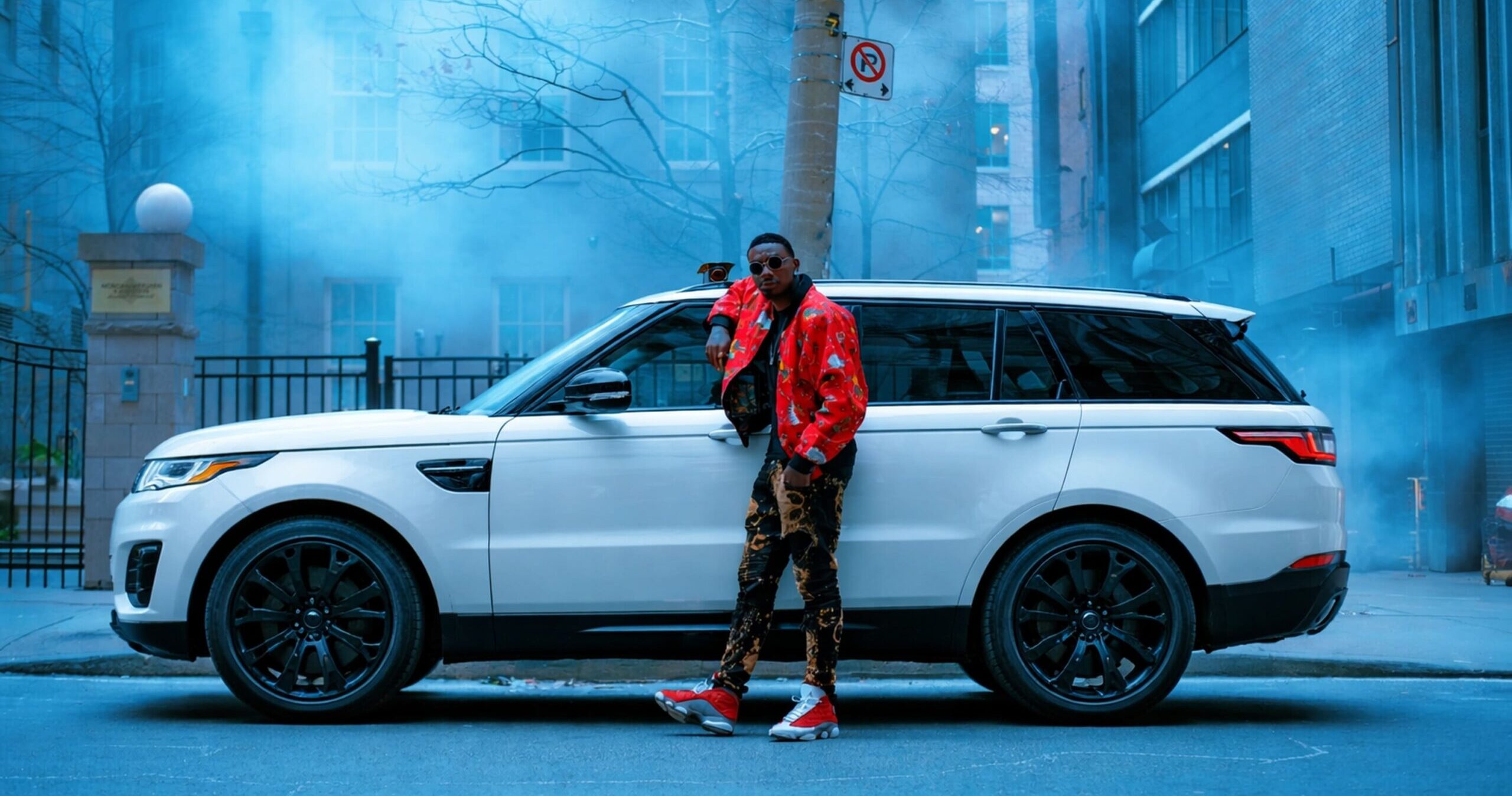 Stylish man with Range Rover at twilight – Rentrals